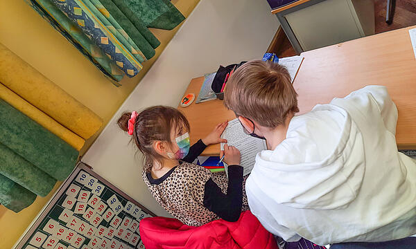 Evgenia (links) macht zusammen mit ihrem Nachhilfelehrer Artjom Hausaufgaben.