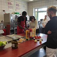 Die Azubis der Berufsschulklasse bereiten beim Besuch der Redaktion gemeinsam Burger-Pattys zu.