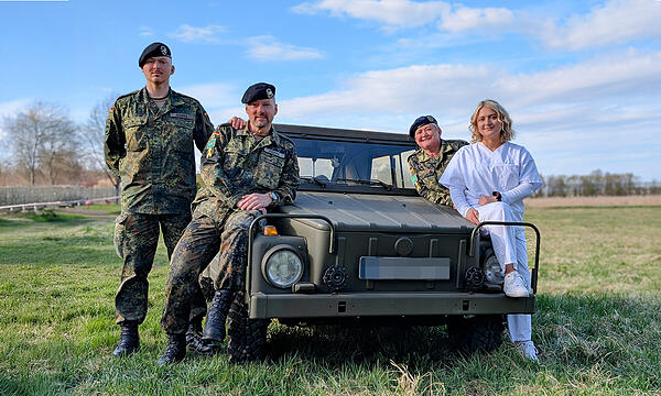 Die Familie Kruppa (von links): Sohn Justin, Vater Bernd, Mama Natalja und Tochter Leonie (vorne rechts) lehnen sich an einen alten Kurierwagen der Bundeswehr, den Vater Bernd restauriert hat.